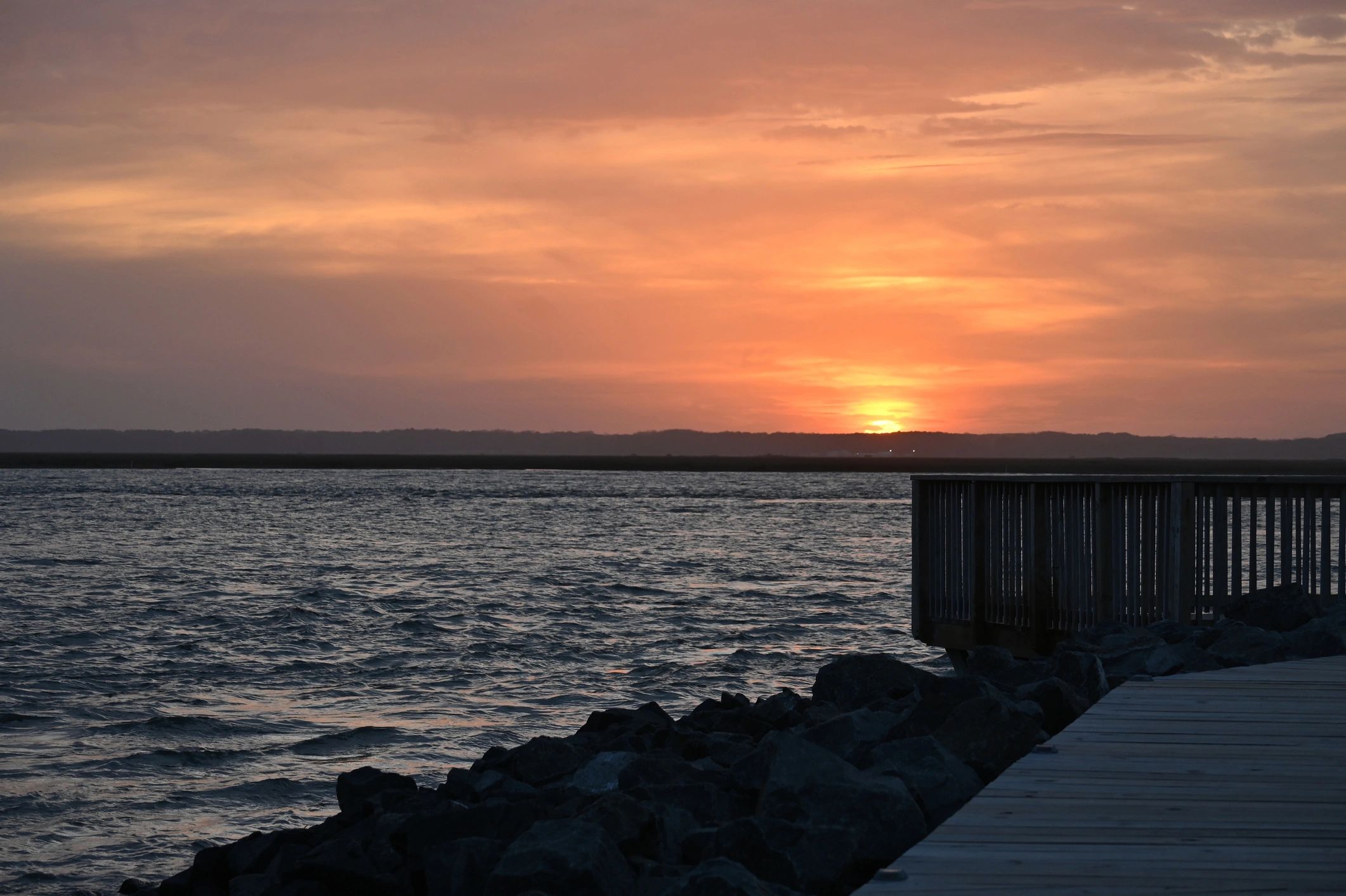 Coastal sunset over calm water